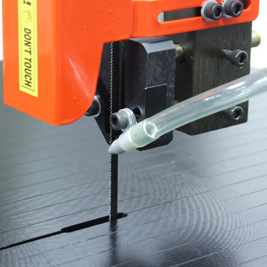 A up close image of the Baileigh BSV-24 showing the bandsaw blade and coolant delivery pipe