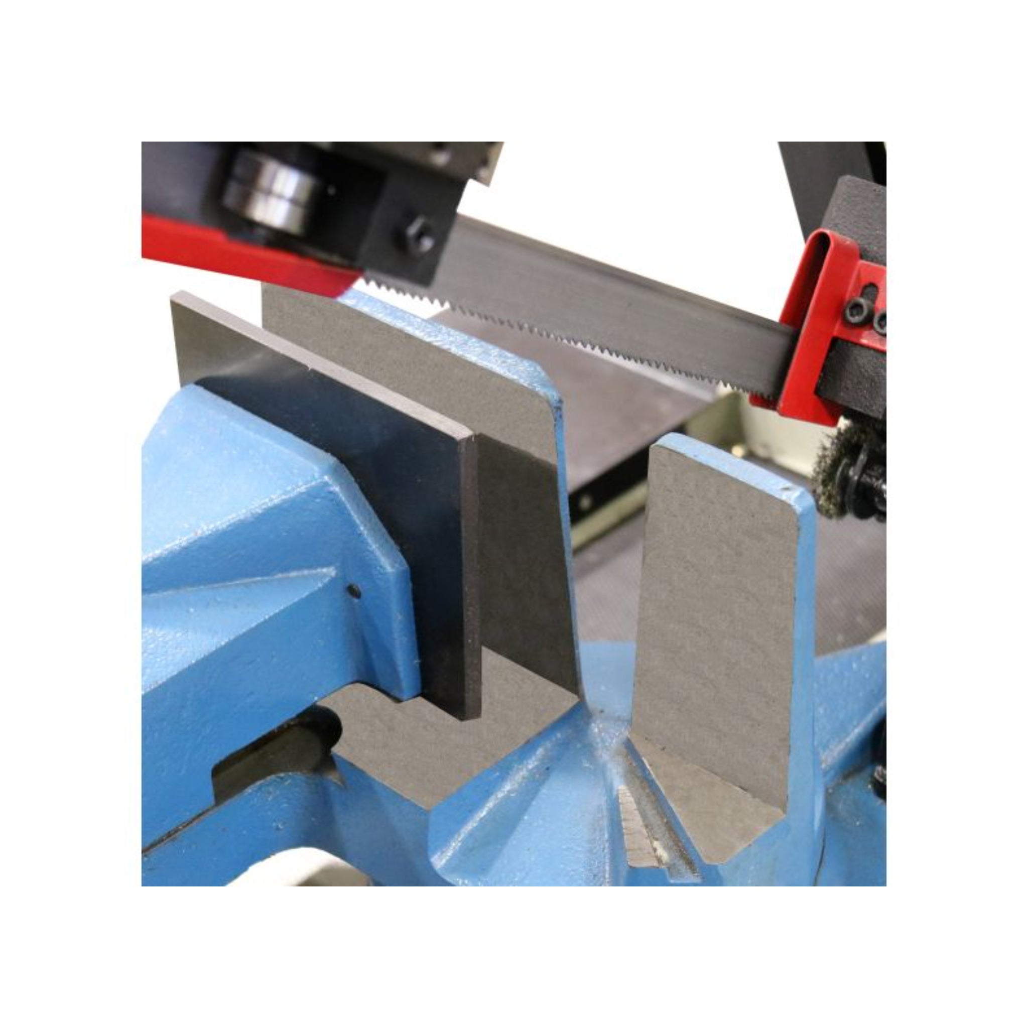 An image taken up close to the vise and blade on the bandsaw